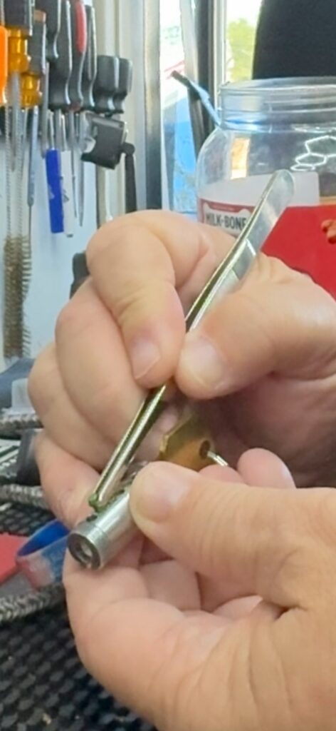 Locksmith servicing a lock cylinder with pinning tweezers