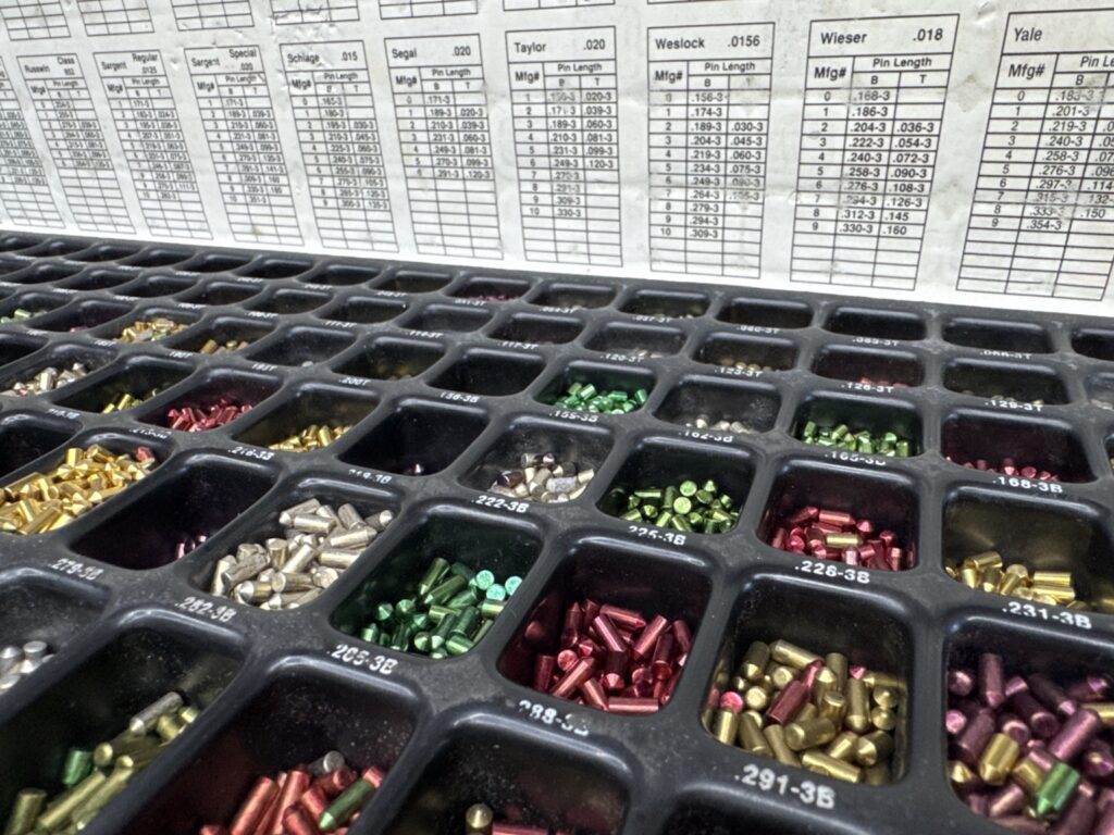Locksmith pinning kit with color-coded lock pins and pin-size charts